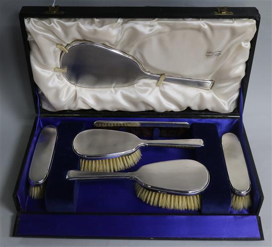 A cased 1940s silver six piece dressing table set, by William Comyns & Sons Ltd.